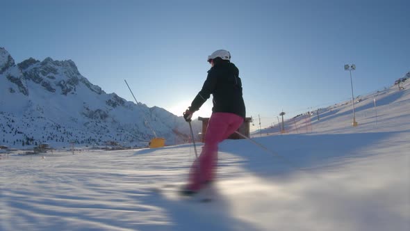 Young woman going downhill with ski and having fun on the slopes