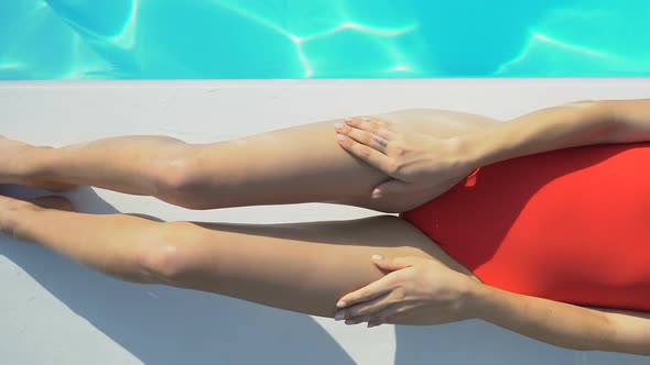 Slim Attractive Lady in Red Swimsuit Lying Near Pool and Sunbathing, Sunscreen