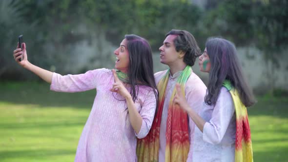Indian people taking selfies on Holi