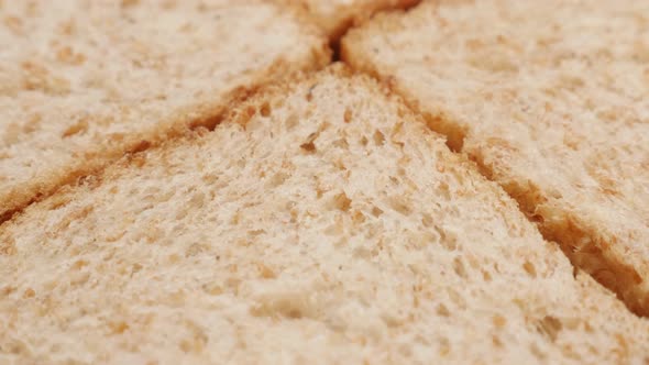 Tilting on four pieces  complete  bread made of full grain close-up 4K 2160p 30fps UltraHD footage -