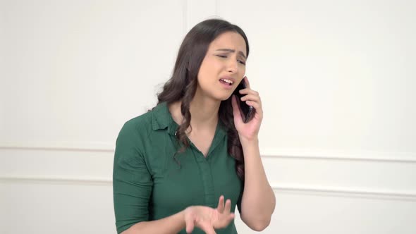 Frustrated Indian woman talking on call