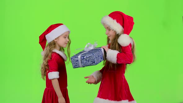 Child Gives a New Year Gift To Her Friend. Green Screen. Slow Motion