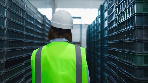 Uniformed Woman Storehouse Worker Examining Supply Boxes Checking Package