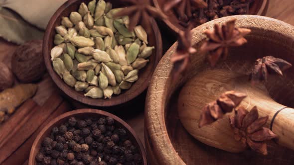 Wood Mortar and Star Anise Spice Species Falling in Slow Motion