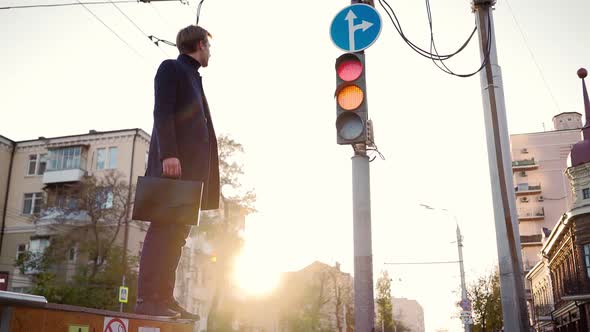 Young Business Man Takes Step Towards Success When the Traffic Light Turns Green