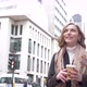 Slow motion shot of smiling blond woman with coffee to go in London - VideoHive Item for Sale