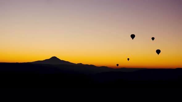 Balloons In The Sky Above The Mountains