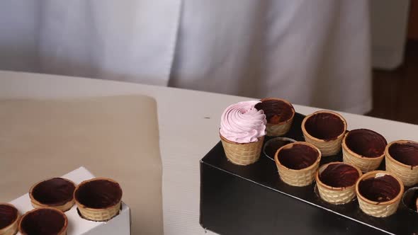 Wafer Cones Smeared Inside With Liquid Chocolate. They Are On Stands.