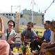 Beautiful girl taking photos of friends at party on a rooftop terrace - VideoHive Item for Sale