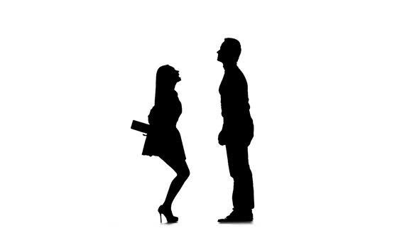 Girl Gives a Gift To Her Beloved Guy. Silhouette. White Background. Slow Motion
