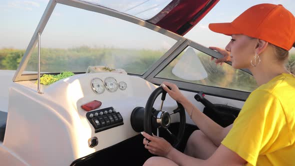 Female Hands Holding the Rudder of a High Speed Motor Boat Close Up