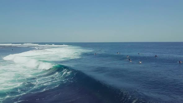 Group of Surfers Doing Surf Stunts and Enjoys Riding the Waves on Summer.