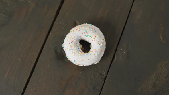 Video of donut with icing on wooden background