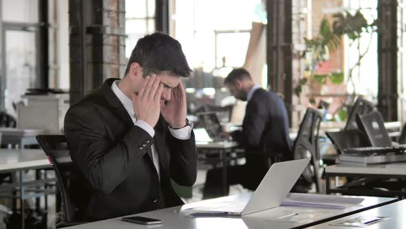 Headache Stressed Businessman at Work