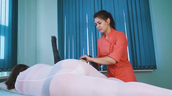 Cosmetologist Does Vacuum Roller Massage To Lady in Clinic