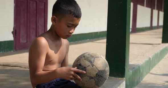 Rural Boy Looking A Old Soccer Ball