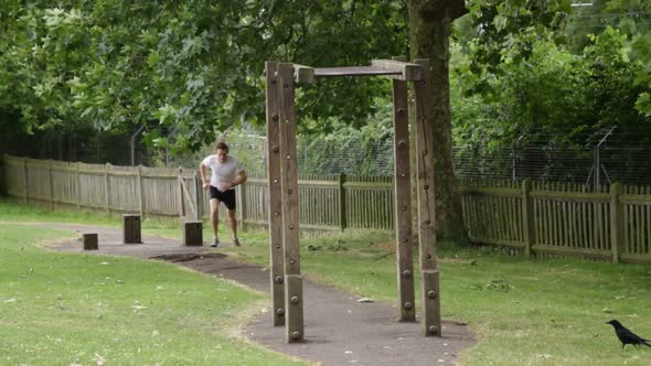 Male running up to parallel bar and exercises