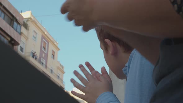 Mom and son applauding to say thanks to medical workers during Covid-19 pandemic