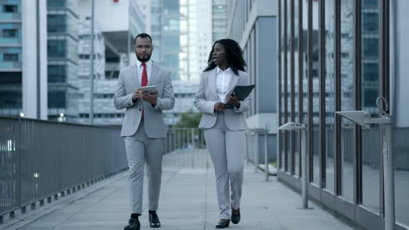 Confident African American Managers Walking on Street and Talking