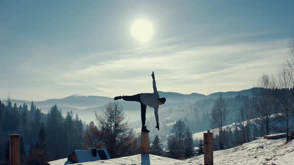 Traveler Practicing Yoga in the Winter Mountains and Enjoying Life. Amazing Winter Adventure in