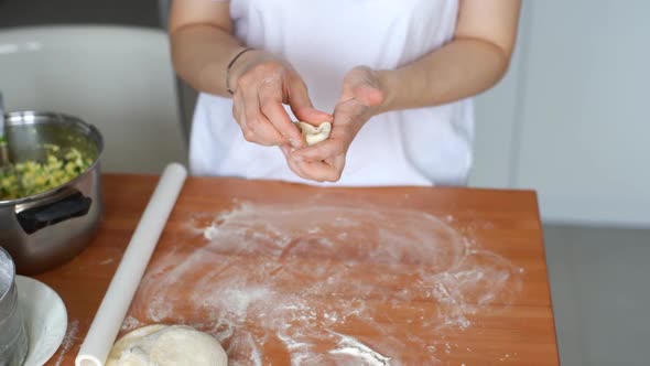 Housewife Sculpts Pies in the Kitchen