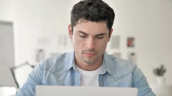 Close Up of Casual Young Man Working on Laptop