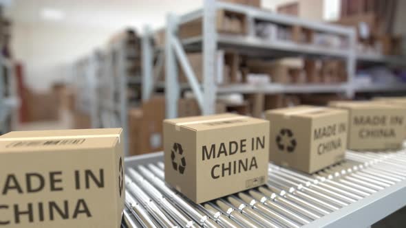 Boxes with MADE IN CHINA Text on Warehouse Conveyor