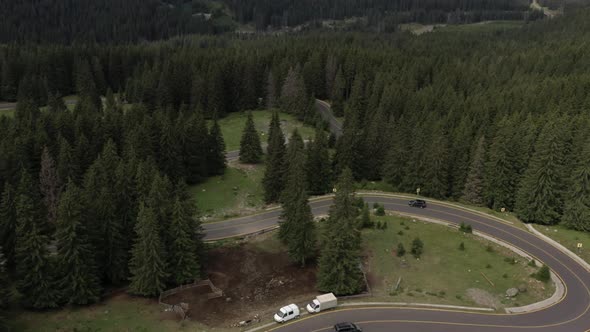 Flying Over The Road Through The Fir Forest In The Mountains