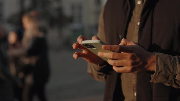 Close Up of Man Texting on Mobile While Standing on Street