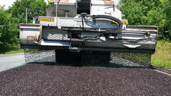 Heavy Machinery Resurfacing a Road Using Micro Asphalt Dressing