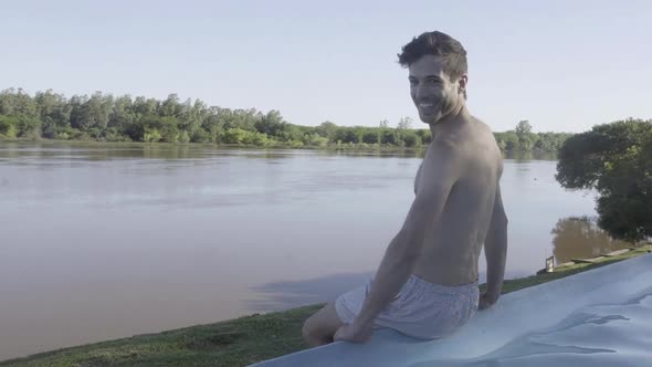 Man sitting on edge of pool