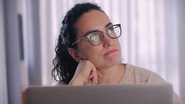 Freelancer Concerned Thoughtful Caucasian Woman Working on Laptop Computer Looking Away Thinking