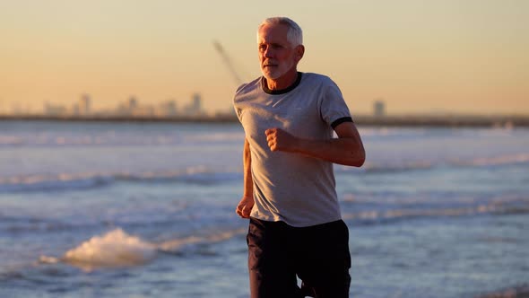 Senior Man Exercising At The Beach