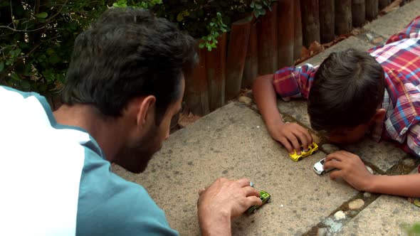 Father and son playing with toys