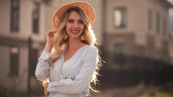 Beautiful Girl in a Summer Hat Posing in Sunlight