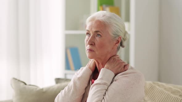 Senior Woman Suffering From Neck Pain at Home
