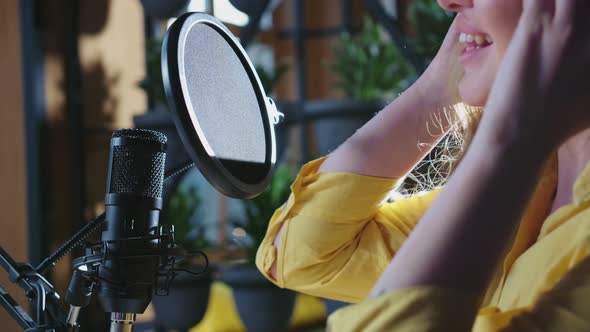 Young Woman Singing and Recording Trendy Songs in Studio