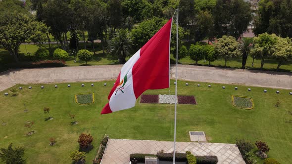 Drone shot of the Peruvian flag waving proudly in the wind in Lima, the capital city of Peru