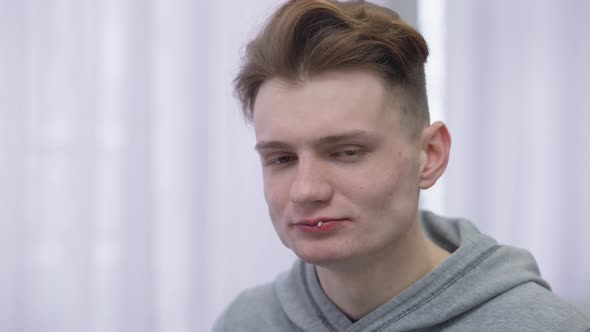 Headshot Portrait of Satisfied Young Man Eating Delicious Rolled Stuffed Pancakes Smiling Looking at