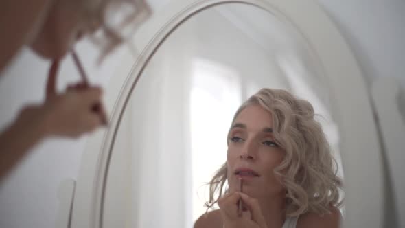 Woman curling hair at home