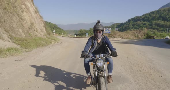 Young Man Riding A Motorcycle On Road