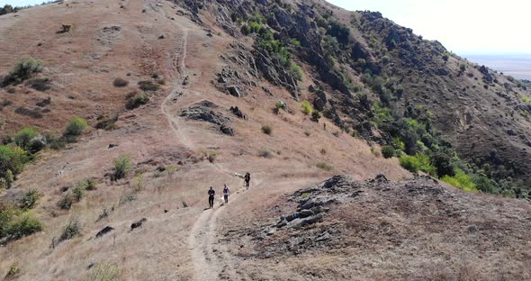 Hikers Walking In The Trail At Macin Mountain Range On A Sunny Summer Day In Tulcea, Dobrogea, Roman