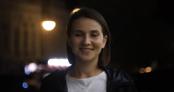 Evening Portrait of a Beautiful Young Woman in City Park