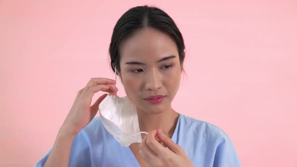 Young Asian Woman Take Off Face Mask Removing From Face