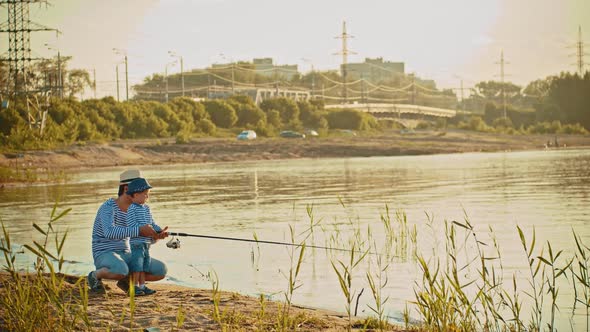 A Father and His Son on Fishing - Father Teaching His Son How To Hold a Fishing Rod