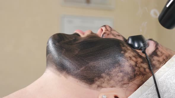Cosmetologist Making Carbon Therapy Face Peeling Procedure