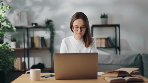 Woman in Eyewear Using Laptop for Studying