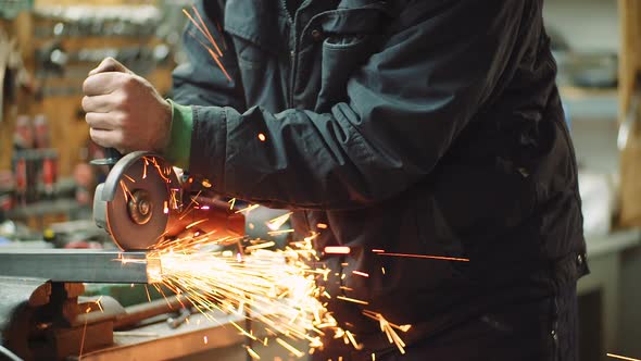 Angle Grinder Cutting Metal at Workshop