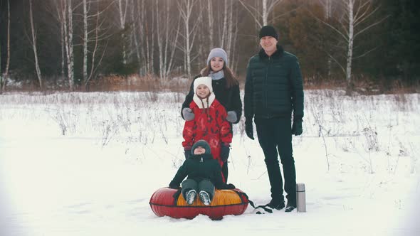 Smiling Family Standing Outdoors Near the Forest