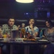 Group of Diverse Friends Communicating with Each Other Sitting at Table of Disco Bar with Colorful - VideoHive Item for Sale